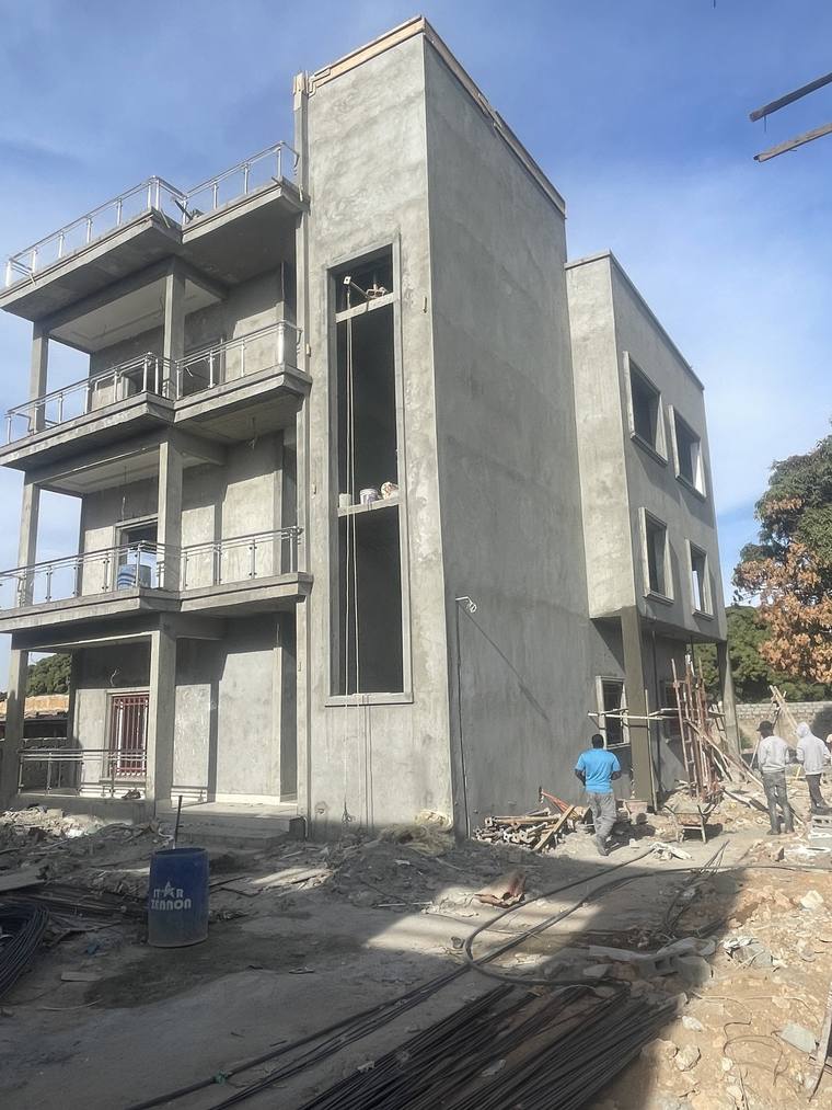 The same structure from the side, rendered, with the stair core rising the full height alongside.