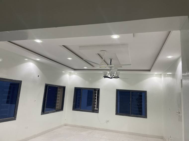 A coffered ceiling in one of the reception rooms, with recessed lighting set into the panels.